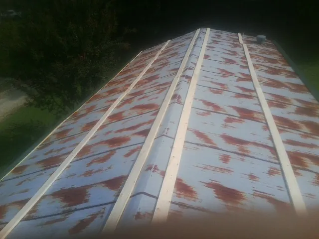 Rusted metal roof panels with new wood purlins before replacement — Storm Damage Roof Repair in Babylon by Roofing Brothers