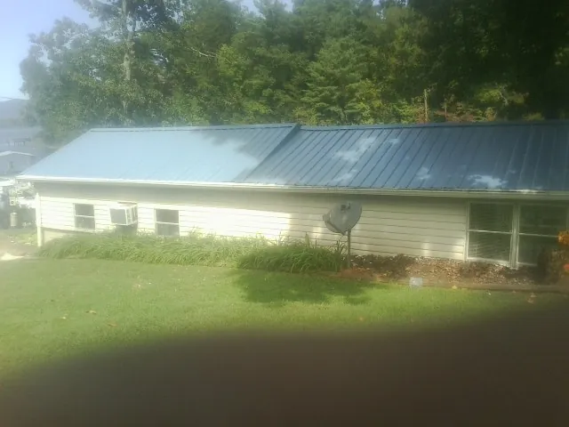 Blue metal roof running the length of a single story home in Babylon
